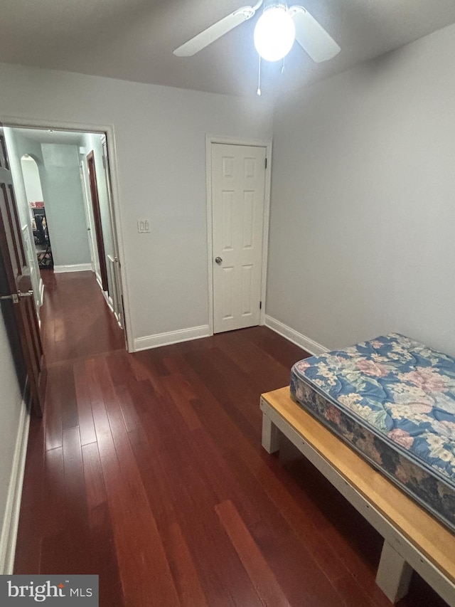 unfurnished bedroom featuring dark hardwood / wood-style floors and ceiling fan