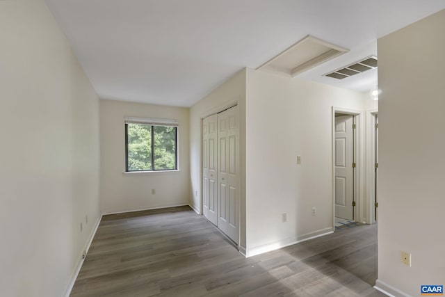 unfurnished room with hardwood / wood-style floors