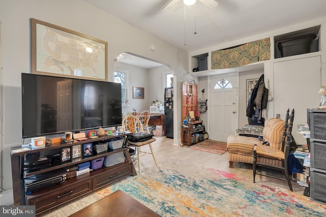 living room featuring ceiling fan and light wood-type flooring