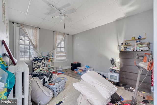 bedroom featuring ceiling fan, a paneled ceiling, and light hardwood / wood-style floors