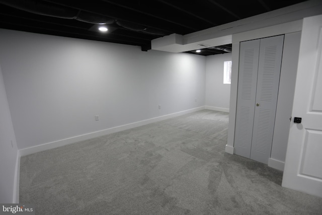 basement featuring light colored carpet