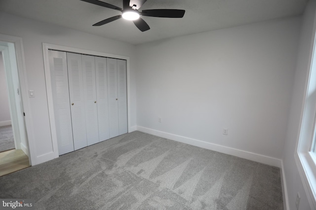 unfurnished bedroom featuring carpet floors, ceiling fan, and a closet