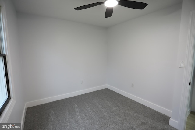 carpeted spare room with ceiling fan