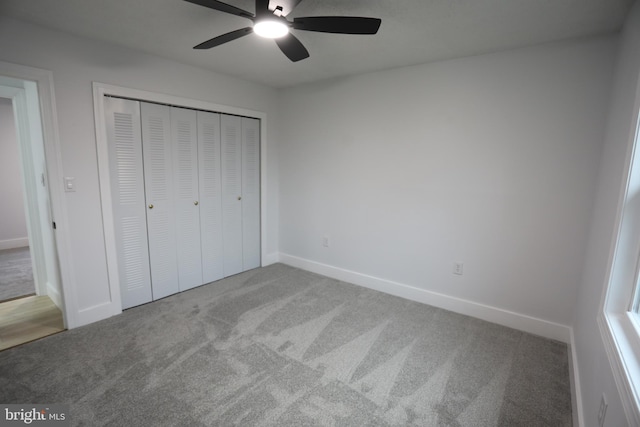 unfurnished bedroom featuring carpet floors, a closet, and ceiling fan