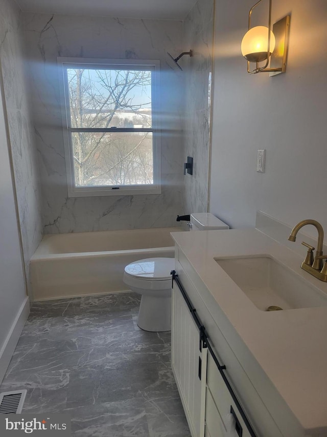 full bathroom with vanity, toilet, and tiled shower / bath combo