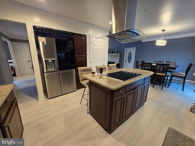 kitchen featuring a center island, stainless steel fridge with ice dispenser, island exhaust hood, hanging light fixtures, and black electric cooktop