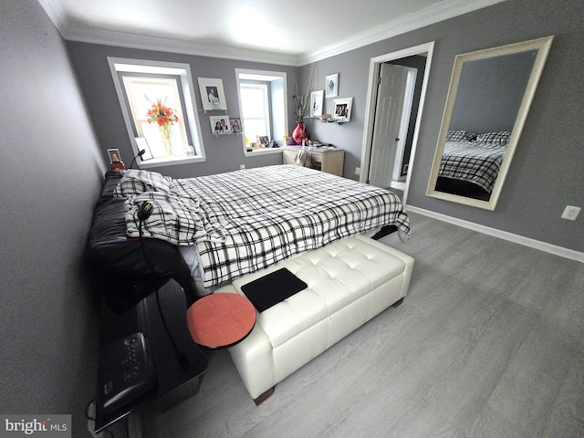 bedroom featuring light wood-type flooring and ornamental molding