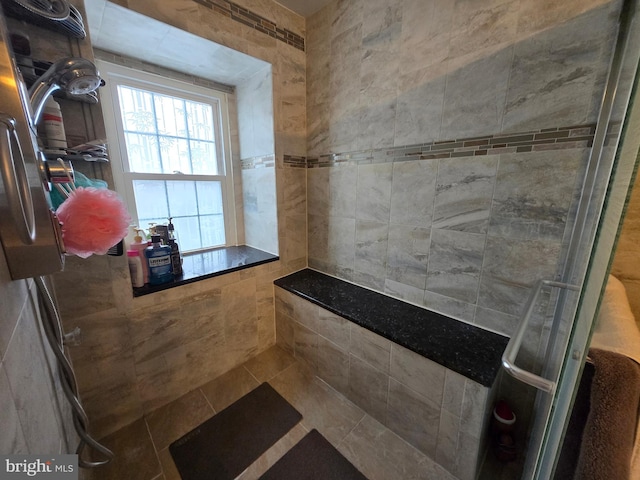 bathroom featuring a shower with shower door