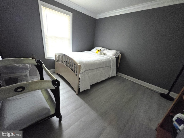 bedroom with hardwood / wood-style floors and ornamental molding