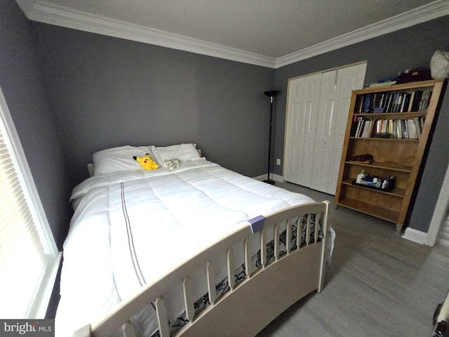 bedroom featuring a closet, ornamental molding, and hardwood / wood-style floors