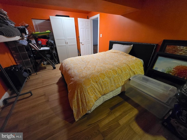 bedroom with hardwood / wood-style flooring