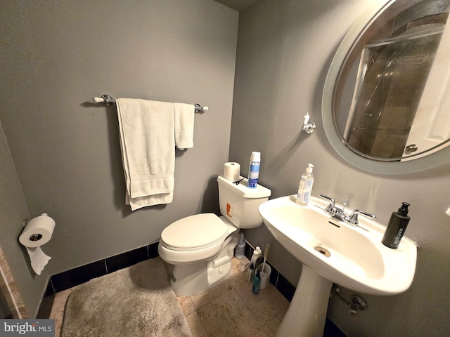 bathroom featuring sink, toilet, and tile patterned floors