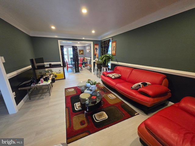 living room with ornamental molding and light hardwood / wood-style floors