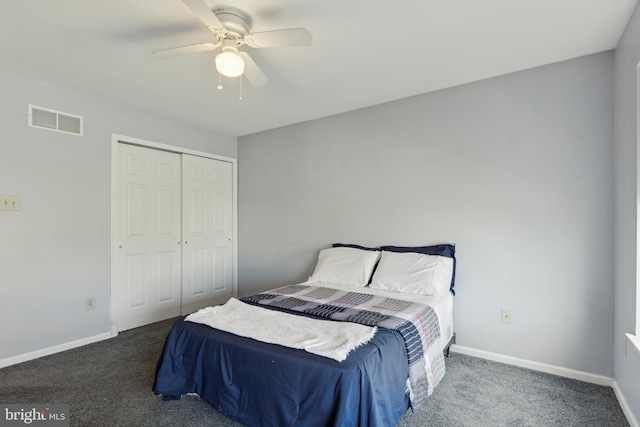 bedroom with dark colored carpet, a closet, visible vents, and baseboards