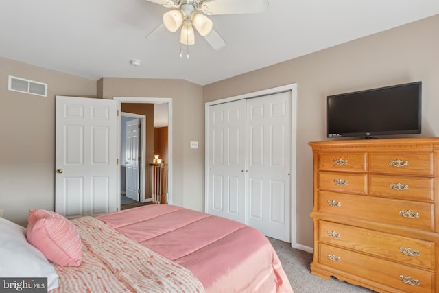 bedroom featuring carpet floors, a closet, visible vents, and a ceiling fan