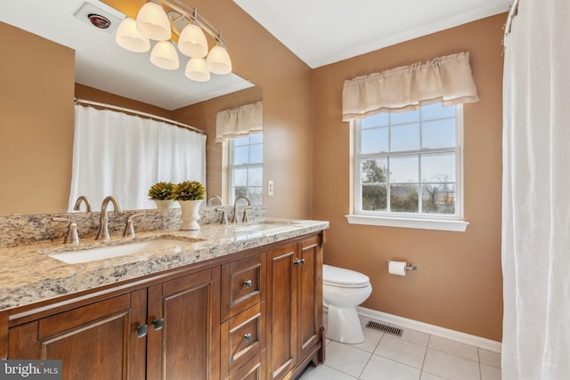 full bathroom with double vanity, visible vents, a sink, and tile patterned floors