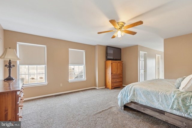 bedroom featuring light carpet, ceiling fan, and baseboards