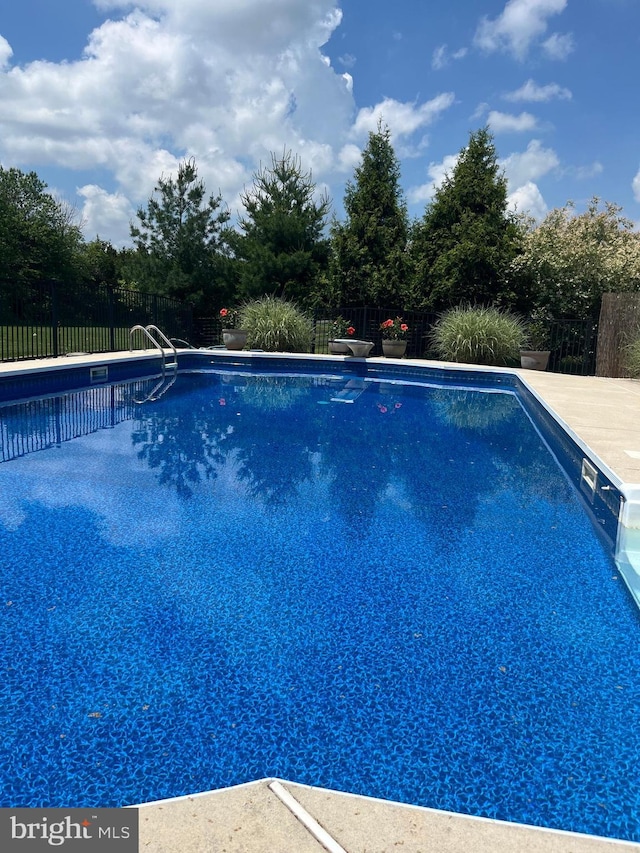 view of swimming pool with a fenced in pool and fence