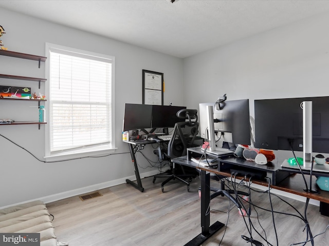 office area with light hardwood / wood-style floors