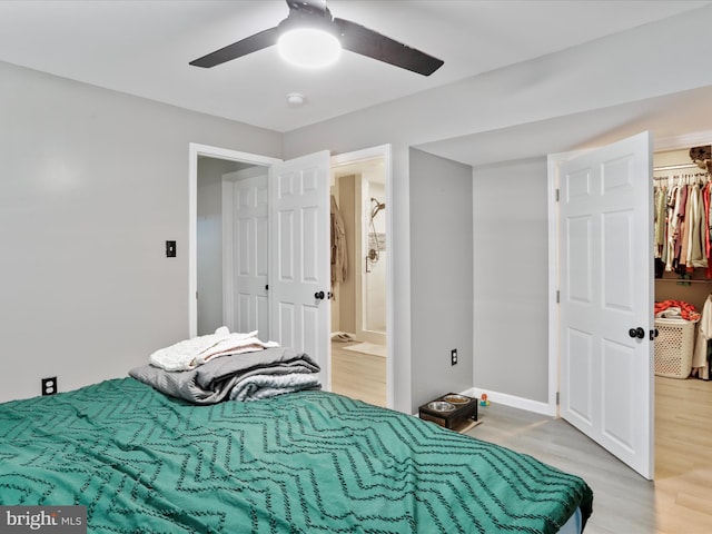 bedroom with ceiling fan, hardwood / wood-style floors, and a closet