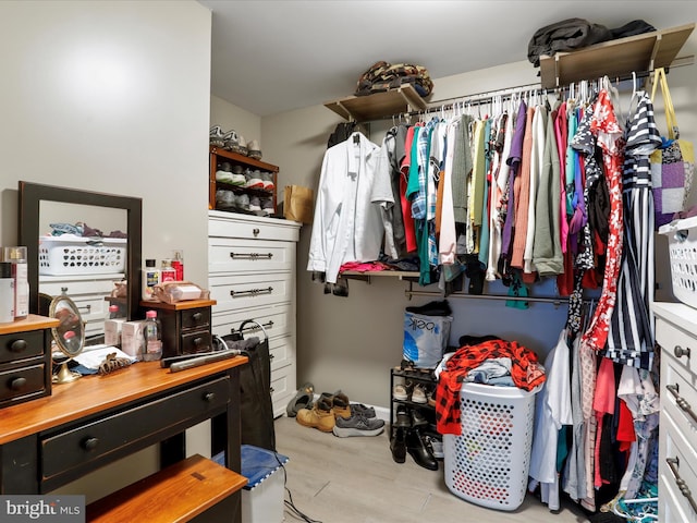 spacious closet with light hardwood / wood-style floors