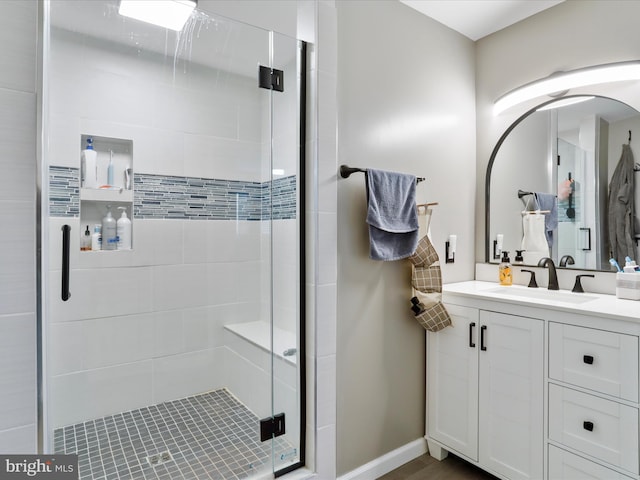 bathroom with vanity and a shower with shower door