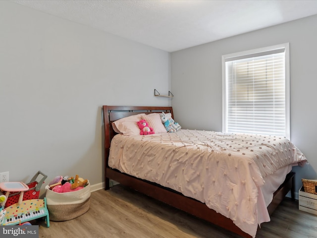 bedroom with wood-type flooring