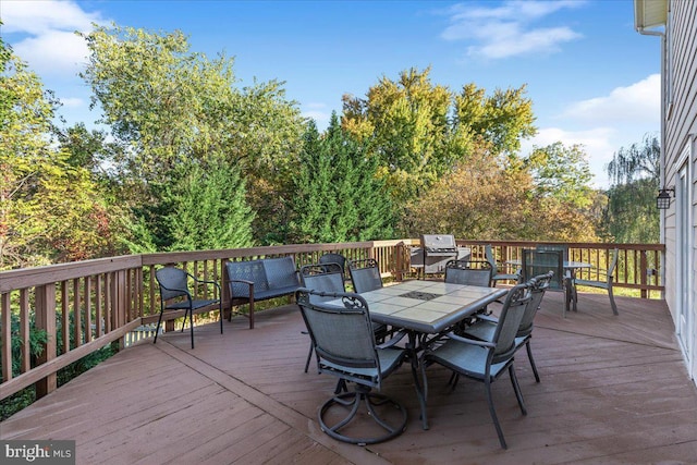 wooden deck featuring outdoor dining area