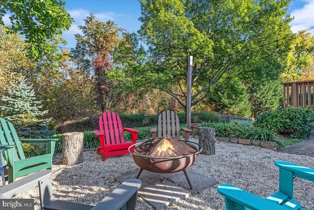 view of patio with an outdoor fire pit and fence