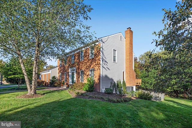 exterior space featuring a lawn and a chimney