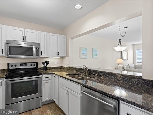 kitchen featuring white cabinetry, sink, dark hardwood / wood-style flooring, and appliances with stainless steel finishes