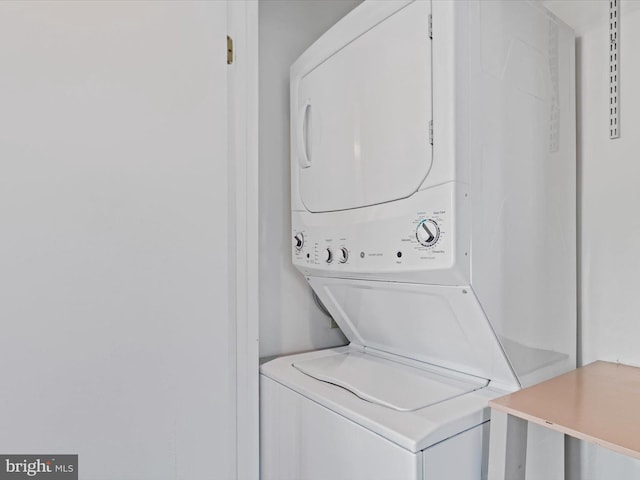 laundry room with stacked washer and dryer