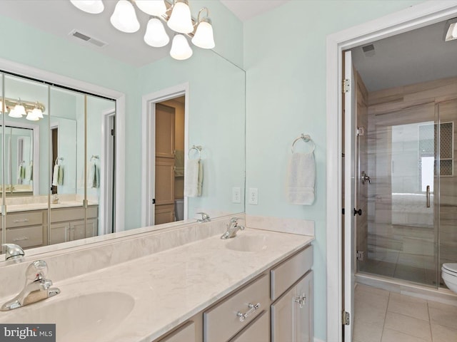 bathroom featuring a shower with door, tile patterned flooring, vanity, a notable chandelier, and toilet