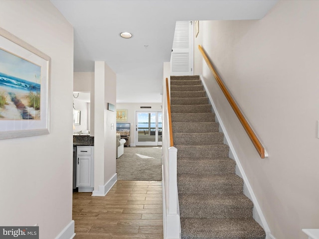 stairs featuring hardwood / wood-style flooring