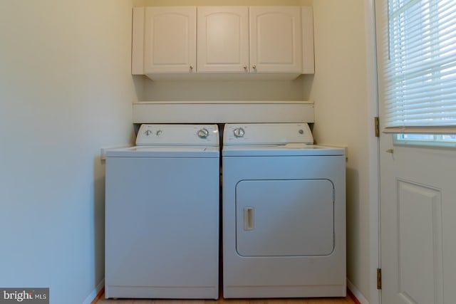 laundry area featuring cabinets and independent washer and dryer