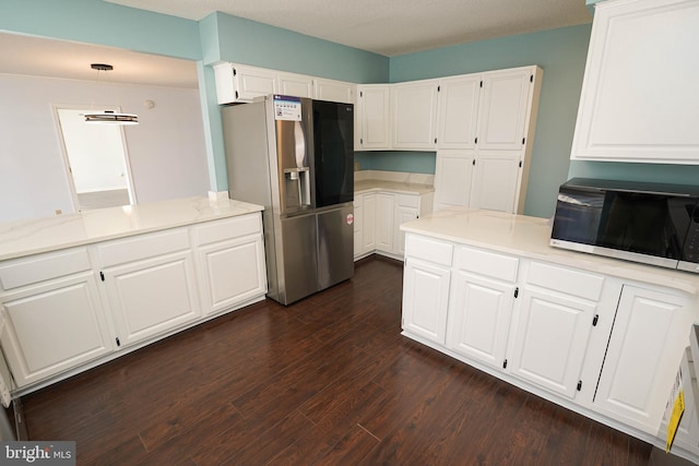 kitchen featuring stainless steel refrigerator with ice dispenser, white cabinetry, dark hardwood / wood-style flooring, kitchen peninsula, and pendant lighting