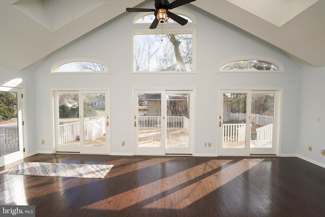 interior space with dark hardwood / wood-style flooring, high vaulted ceiling, and ceiling fan