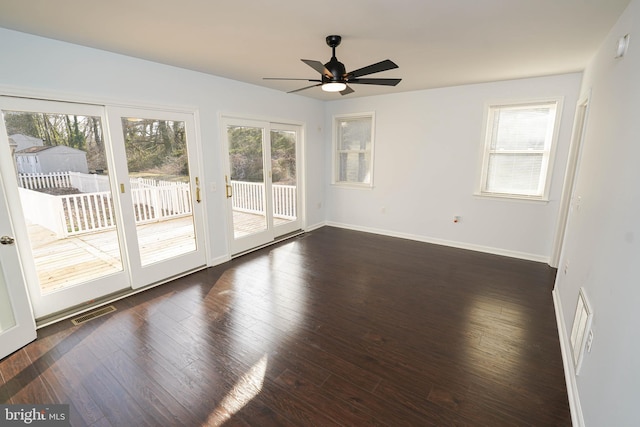 unfurnished room featuring ceiling fan and dark hardwood / wood-style flooring