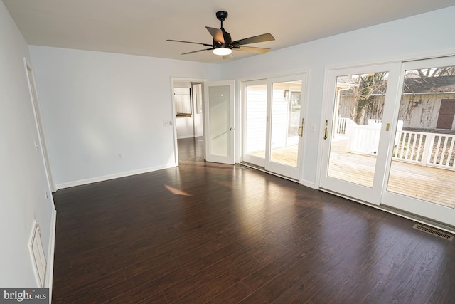 empty room featuring dark wood-type flooring and ceiling fan