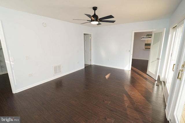 spare room featuring dark hardwood / wood-style flooring and ceiling fan