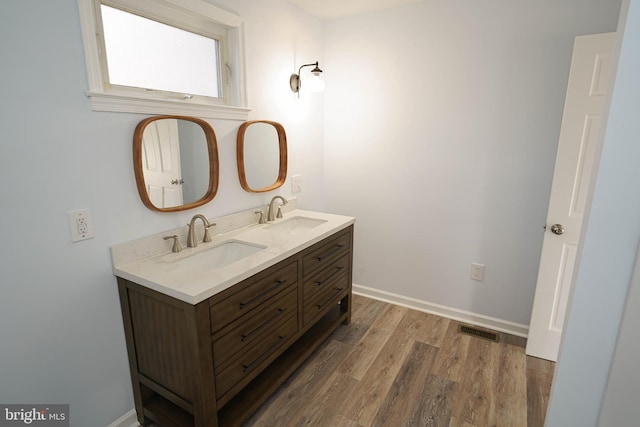 bathroom featuring hardwood / wood-style flooring and vanity