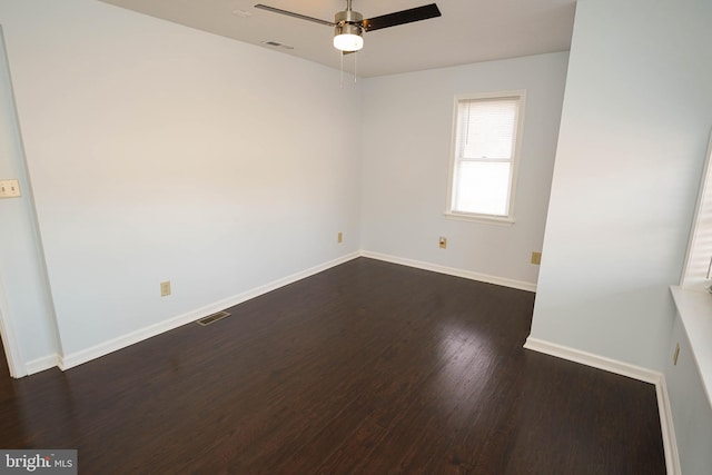 spare room with dark hardwood / wood-style floors and ceiling fan