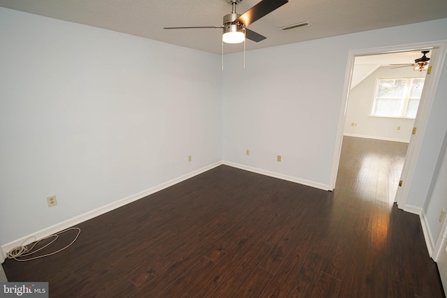 empty room with dark wood-type flooring, ceiling fan, and a textured ceiling