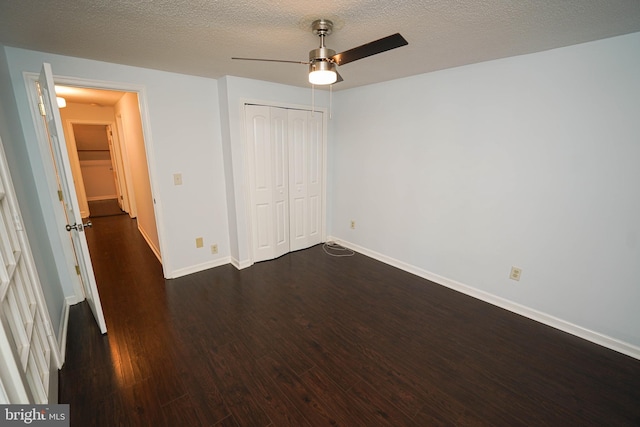 unfurnished bedroom featuring dark hardwood / wood-style flooring, ceiling fan, a closet, and a textured ceiling