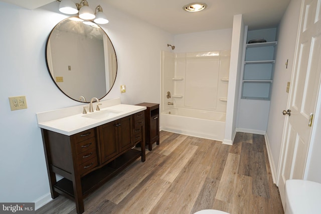 bathroom with bathing tub / shower combination, hardwood / wood-style floors, and vanity