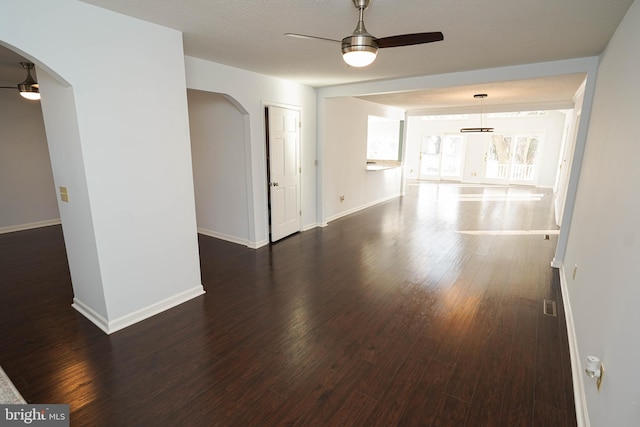 spare room with dark hardwood / wood-style floors and ceiling fan