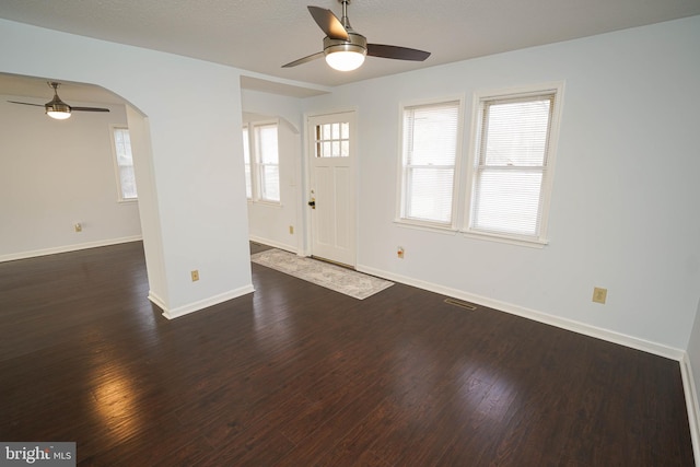 entrance foyer with ceiling fan and dark hardwood / wood-style flooring