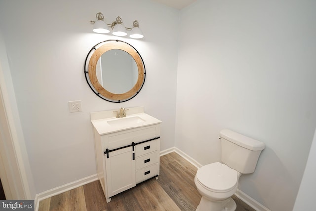 bathroom featuring vanity, toilet, and hardwood / wood-style floors