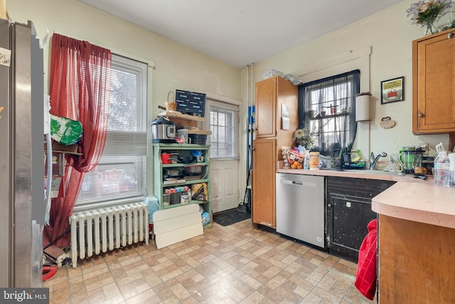 kitchen featuring radiator, stainless steel dishwasher, and sink