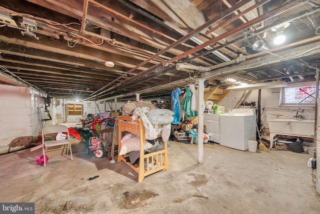 basement featuring sink and independent washer and dryer